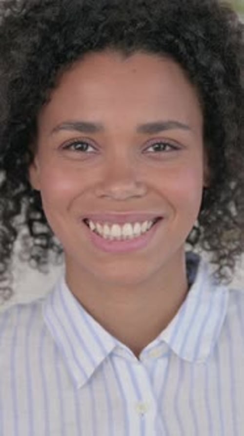 Woman Smiles Happily in Vertical Portrait Video