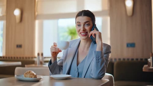 Confident Lady Talking Mobile Phone Sitting Light Cozy Cafeteria Table Closeup