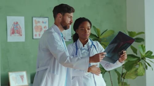 Two Doctors Reviewing Patient X-Ray in Medical Office