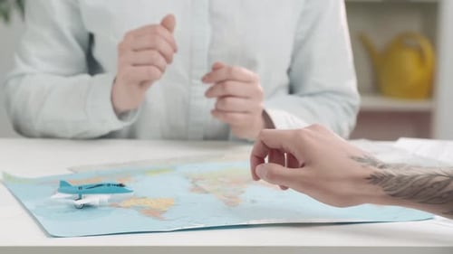 Planning a Vacation with a World Map and Plane