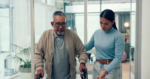 Senior Man Uses Walker with Woman's Support