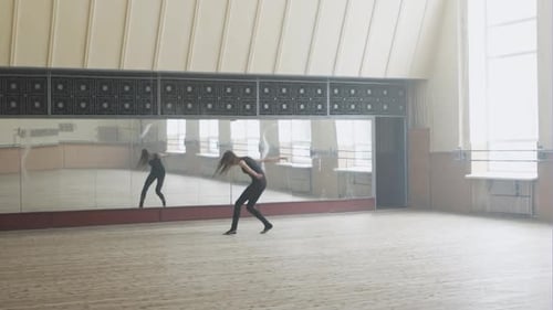 Beautiful Ballerina Posing in Front of Mirror in the Dance Studio