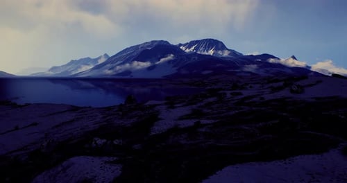 Majestic Mountain Landscape Under a Cloudy Sky During Twilight Hours