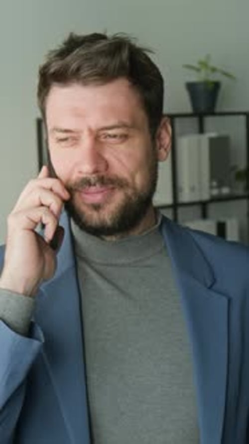 Business Professional Having Phone Conversation in Office