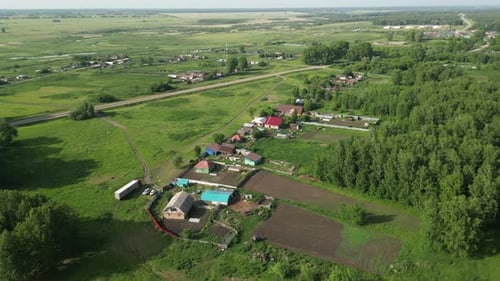 Verdant Meadows and Vibrant Houses Nestling Across Picturesque Rural Landscape Capturing Serene
