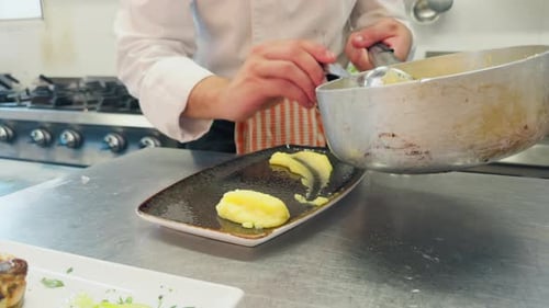 Chef is Cooking Polenta in a Restaurant Kitchen