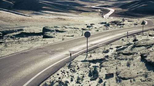 Winding Road Through the Vast Steppe Landscape of Mongolia Under Clear Skies