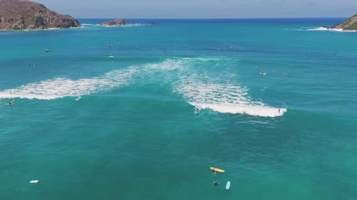 Aerial View of a Rocky Coastline with Turquoise Ocean Waves