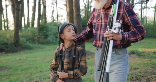 Boy and Senior Prepare to Fish in Forest