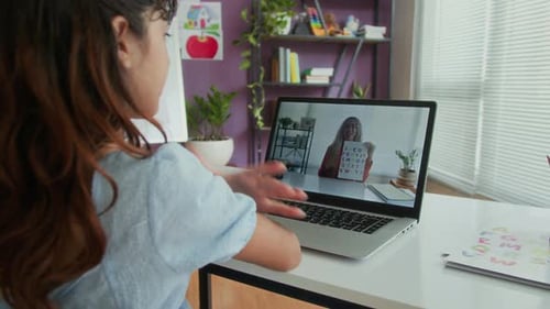 Young Girl Learning Alphabet With Remote Teacher