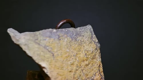 Antique Padlock Resting on Jagged Stones