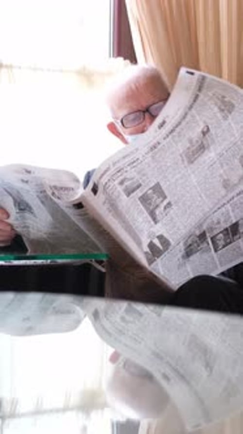 An Elderly Man Reads a Newspaper Enjoying a Cozy Atmosphere of Comfort and Tranquility