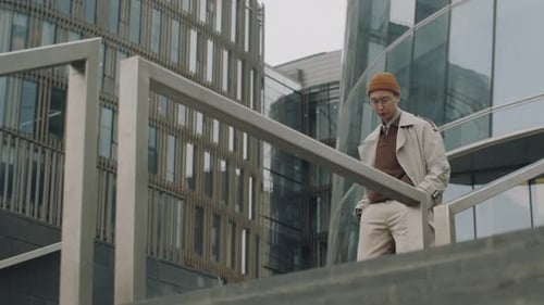 Asian Guy Walking down Stairs on Street