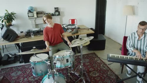 Four Musicians Playing Instruments Together in Studio