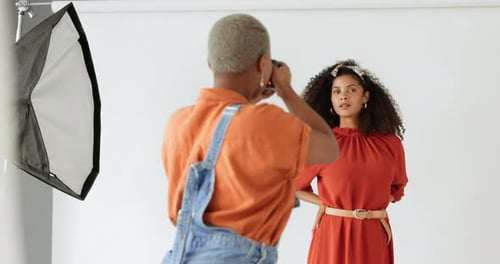 Fashion Model Posing for Photographer in Bright Studio