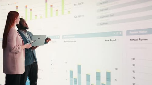 Analyzing Economic Data Graphs Laptop and Businesspeople