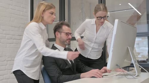 Business Colleagues Working on Computer in Office