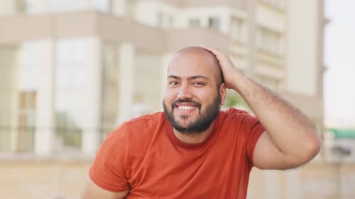 Bald indian Man Playing with Hair