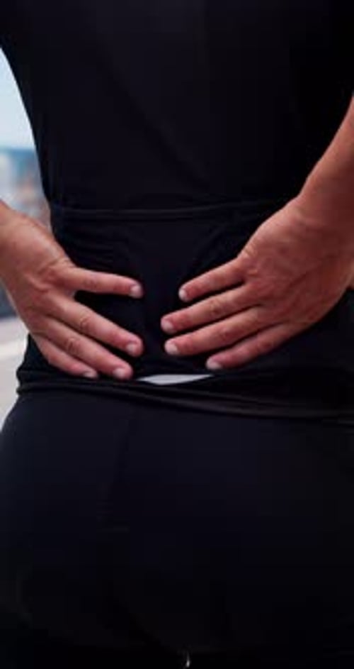 Hands, back pain and fitness in city with injury, muscle strain and massage for relief on break