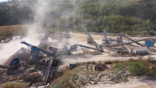 Aerial view of stone quarry conveyor belt system in operation, stone jaw crusher plant