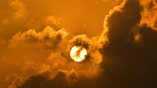 Majestic Sunrise Emerging Through Clouds