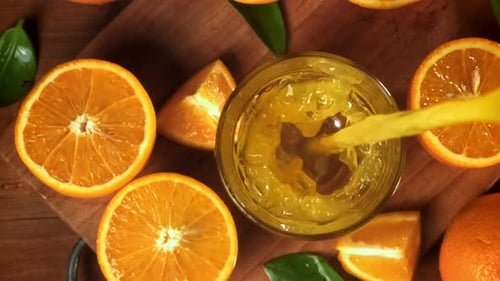 Orange Juice Pouring into Glass Still Life