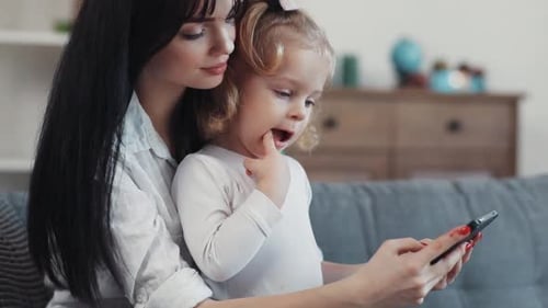 Mother and Child using a Mobile Phone at Home
