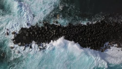 Overhead View of Waves Splash on Rocks