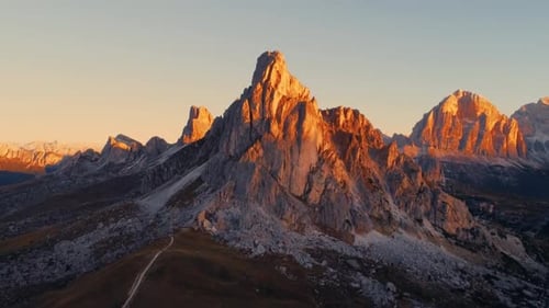 Golden Hour Sunlight Bathes Majestic Dolomite Mountain Peaks in Warm Light