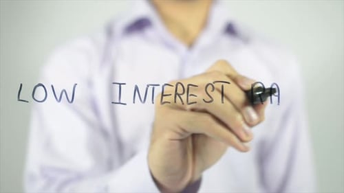 Man Writes Low Interest Rates on Glass