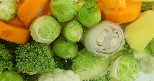 Vegetable mix for making soup in boiling water with air bubbles.