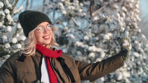 Happy Beautiful Young Woman Posing Taking Selfie Photo Video Use Smartphone at Winter Sunny Forest