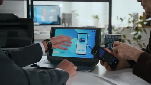 Unrecognizable Bank Employee Telling Elderly Woman About their Smartphone App