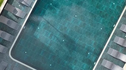 Aerial Video Swimming Pool with Sun Loungers and Clean Lines