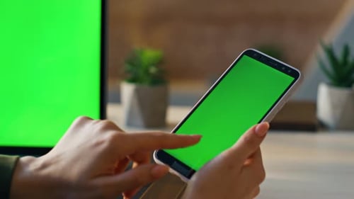 Woman Hand Touching Green Screen Mobile Touchscreen Answering Call at Office Workplace