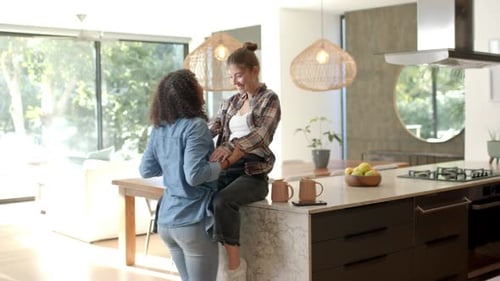 Two Young Women Dancing Together at Home
