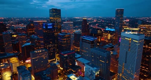 Downtown Houston, Texas, USA at night. Drone footage over the luminous cityscape.