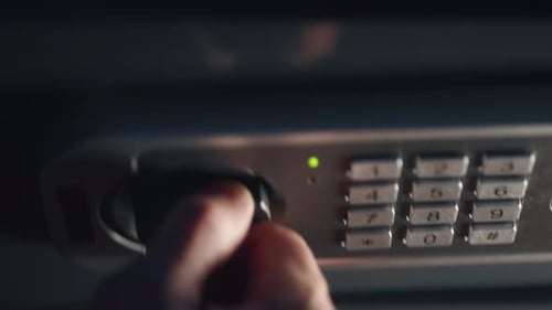 A Businessman is Dialing Secret Code and Opening Safe and Putting Money