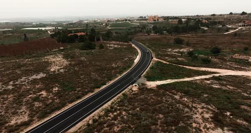 Aerial View of Winding Road Through Rural Landscape