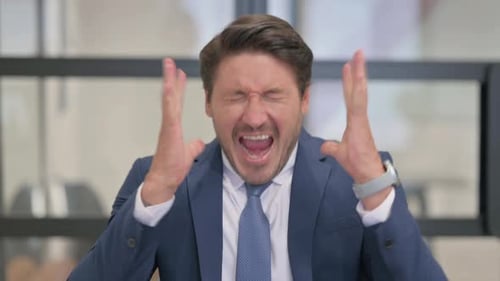 Frustrated Business Man Yelling Loudly in Office