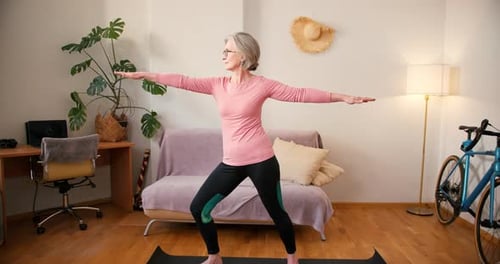 Senior Woman Doing Yoga Exercise at Home