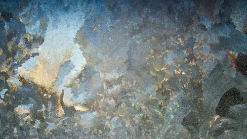 Icy Frost Patterns on Glass Window in Winter