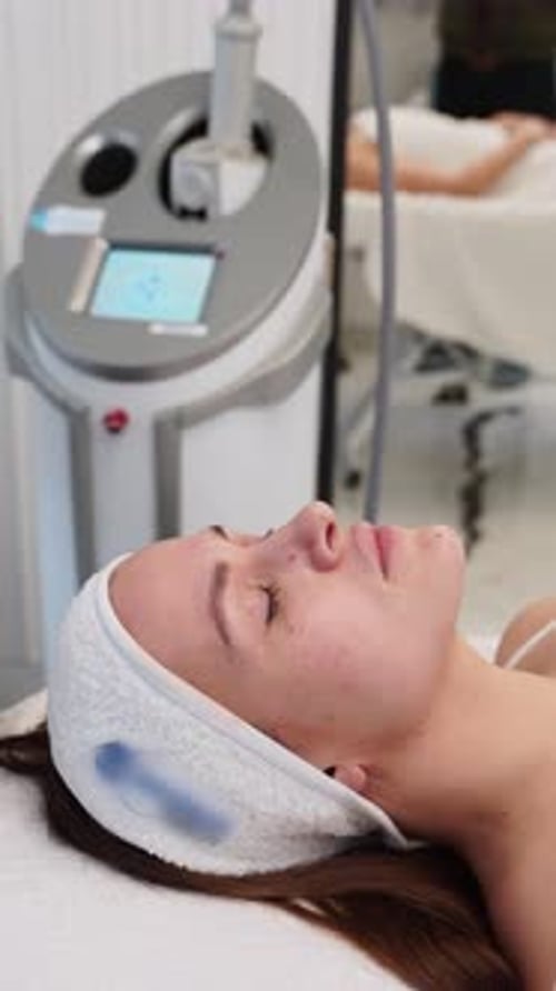 Professional Aesthetician Performs Endospheres Therapy Facial at Clinic Relaxed Female Undergoing