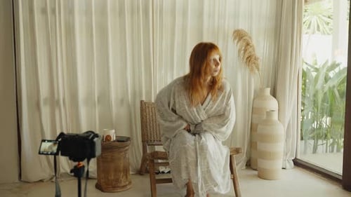 Red Haired Woman Recording Fashion Blog in Home Studio