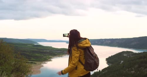 4k video footage of a woman taking a photo of the view outside