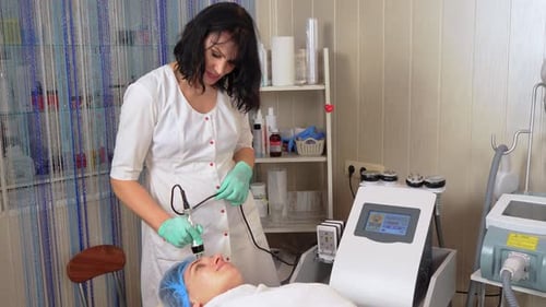 Lifting Procedure in Face Beautician Conducts Facial Rejuvenation Procedure for Woman