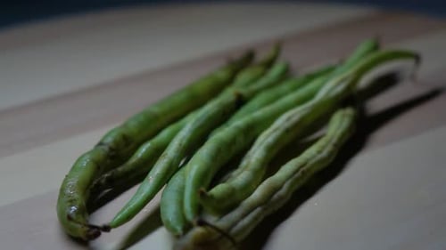 close up of some green bean stalks with a rotating shot.