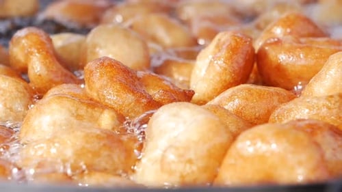 Traditional Fried Sweets Lokma in Sugar Syrup in Slow Motion