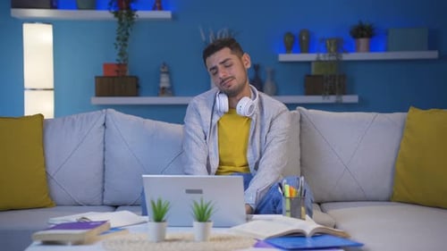 Man getting tired while using computer at night.