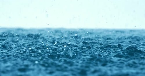 Rain water drops falling in super slow motion.